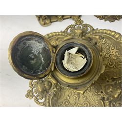 Collection of victorian and later brass desk accessories, to include a letter holder with cherub design, ink well of square form with hinged lid, brass table bell, brass casket with relief decoration, etc  