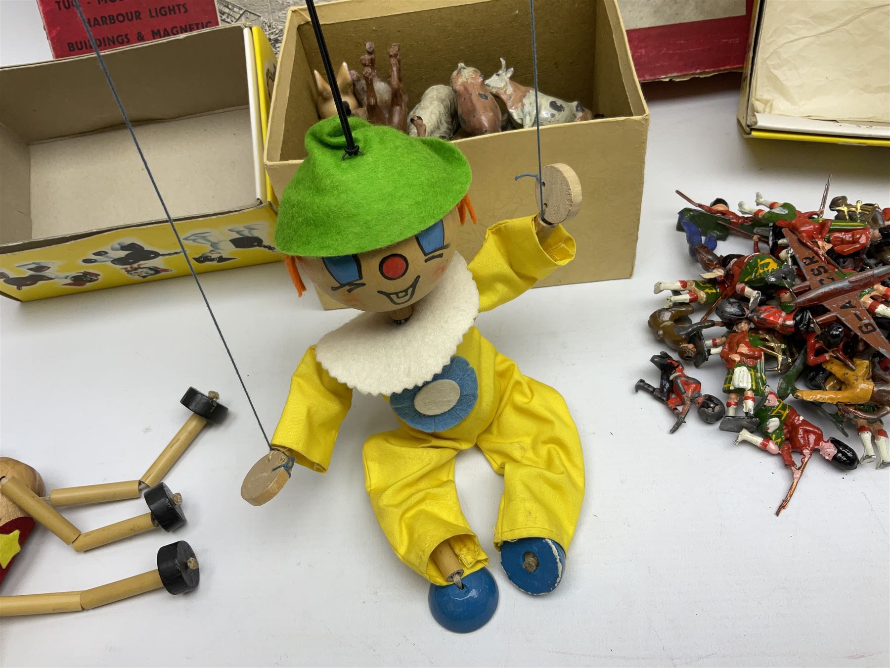 Vintage toys comprising 'Docking RMS Queen Mary' game, two boxed Pelham puppets, quantity of painted metal British soldiers to include Guardsmen, painted farm animal figures