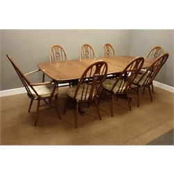  Ercol golden dawn finish elm dining table with three additional leaves (101cm x 162cm - 255cm (with leaves)), and eight stick and hoop chairs with swan spats  