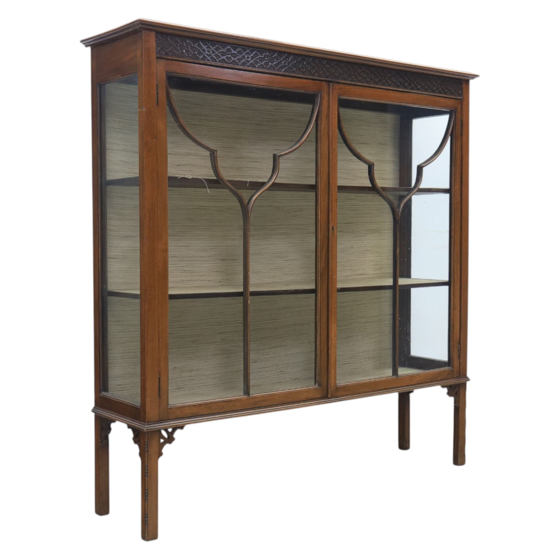 Edwardian mahogany display cabinet, blind-fretwork frieze over astragal glazed doors, square legs with fretwork detail