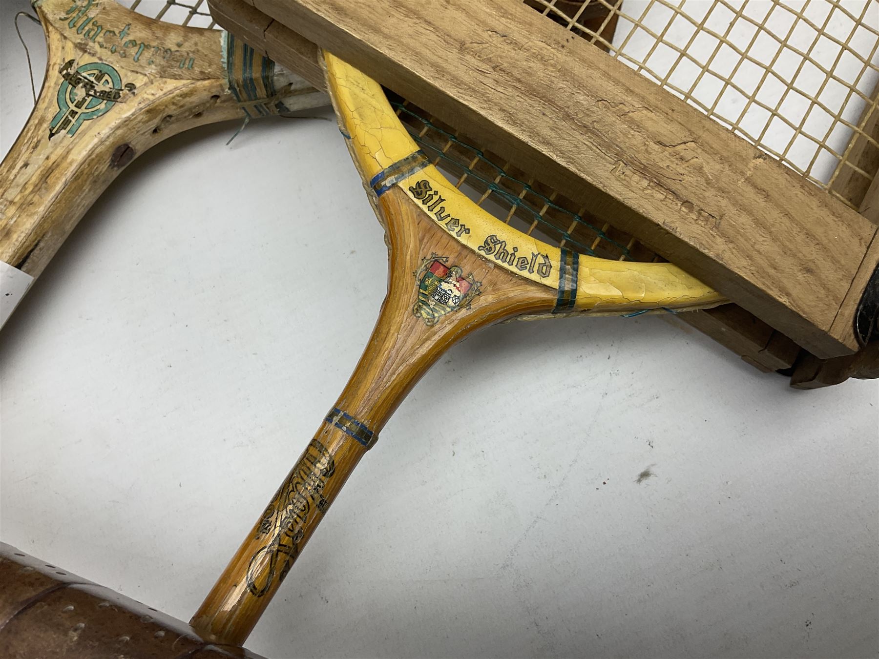 Quantity of early 20th century and later tennis rackets, to include Artus Majesty, Dunlop Alpha, Atlas Silver Shield and Raleigh Konni, together with a stitched rugby ball