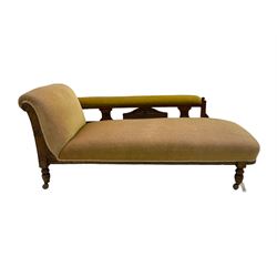 Late Victorian oak framed chaise longue, carved with shell and flower head motifs, on turned feet