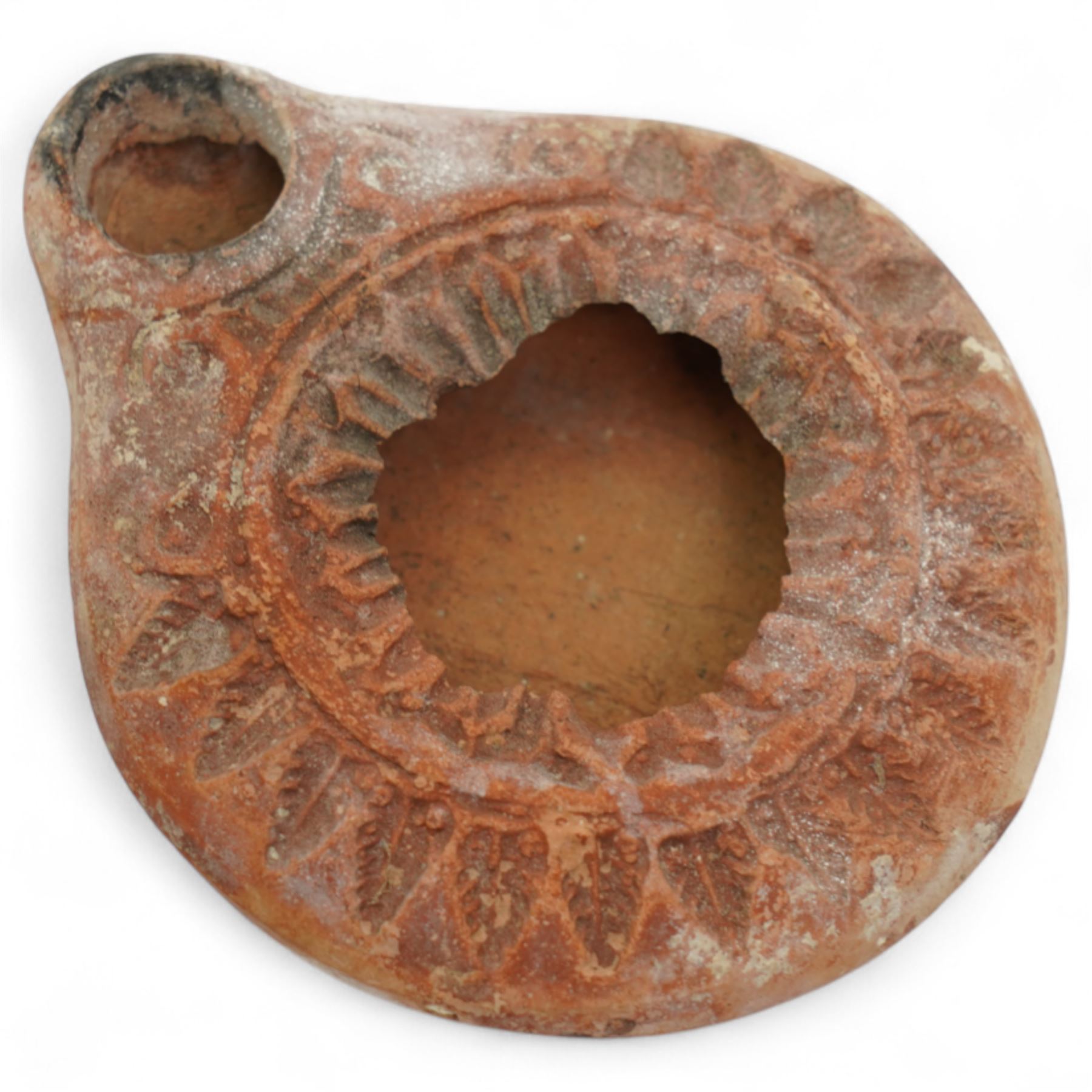 A group of five ancient terracotta oil lamps - Near East and Eastern Mediterranean (c.3rd millennium BC-9th century AD) comprising: Levantine open bowl-type lamp (c.3rd-2nd millennium BC) hand-formed with pinched spout and rounded profile; Near Eastern pinched-spout lamp (c.1200 BC) of coarse red clay with wide central fill hole; Roman oil lamp (c.1st-2nd century AD) with flared spout and a rosette-stamped base; Roman circular oil lamp (c.2nd-3rd century AD) with deeply moulded floral decoration in high relief around the fill hole; and a larger Early Islamic (Arab) lamp (c.7th-9th century AD) decorated with incised geometric motifs to the upper surface
Provenance: By the vendor’s repute, acquired/collected in the Middle East (Dead Sea area/Syria) in the 1960s