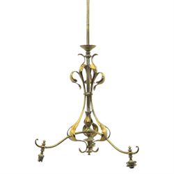20th century Art Nouveau brass wall light, vertical stem with three scrolling arms terminating in lamp holders, central baluster element with curving supports