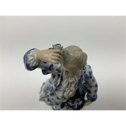 Meissen blue and white figure, modelled as a gentleman holding a hat of flowers, raised upon Greek key design base, with blue crossed swords and impressed C 73 and 149 marks beneath, H18cm