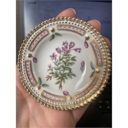 Royal Copenhagen Flora Danica wares, comprising covered mustard pot with naturalistically modelled vine handles and decorated with Cushion Pink (Cucubalius Acaulis) H8cm, milk jug decorated with Maiden Pink (Dianthus Deltoides) H7cm, covered dish decorated with Dwarf Milkwort (Polygala Amarum) W8cm, oval salt cellar decorated with Alpine Squill (Scilla Bifolia) W11cm, egg cup, pin dish and cased hand mirror, various Latin specimen inscriptions to base, all with printed and painted marks beneath (7)