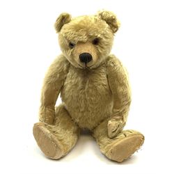 Chad Valley large teddy bear c1930s with wood wool filled blond mohair body, jointed swivel head with glass eyes, shaved muzzle with vertically stitched nose and mouth and jointed limbs H21