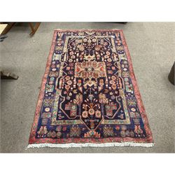 Persian Hamadan blue ground rug, decorated with stylised flower heads 
