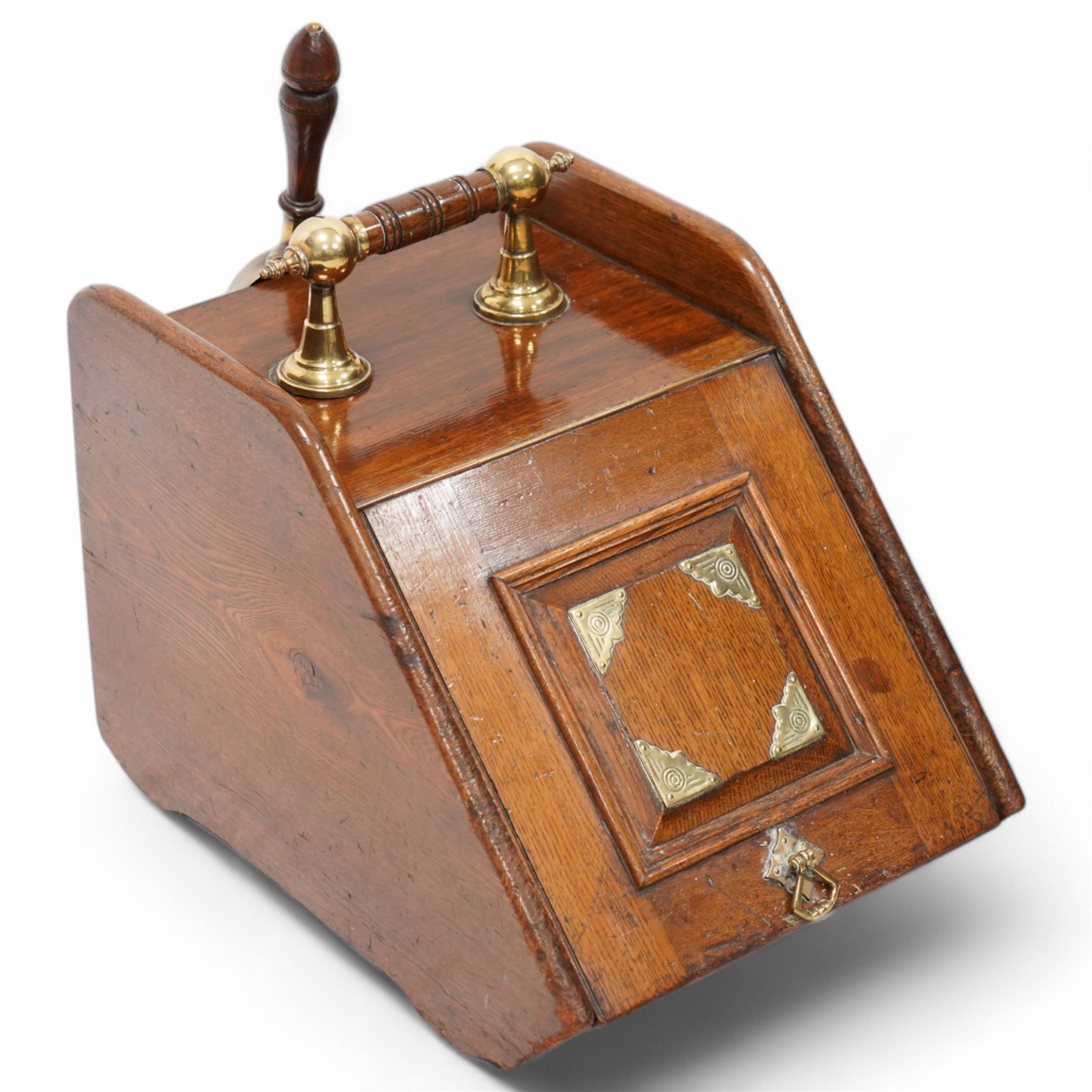 Late Victorian oak coal box, with brass mounted decoration, the hinged lid lifting to reveal removable interior lining, with scoop