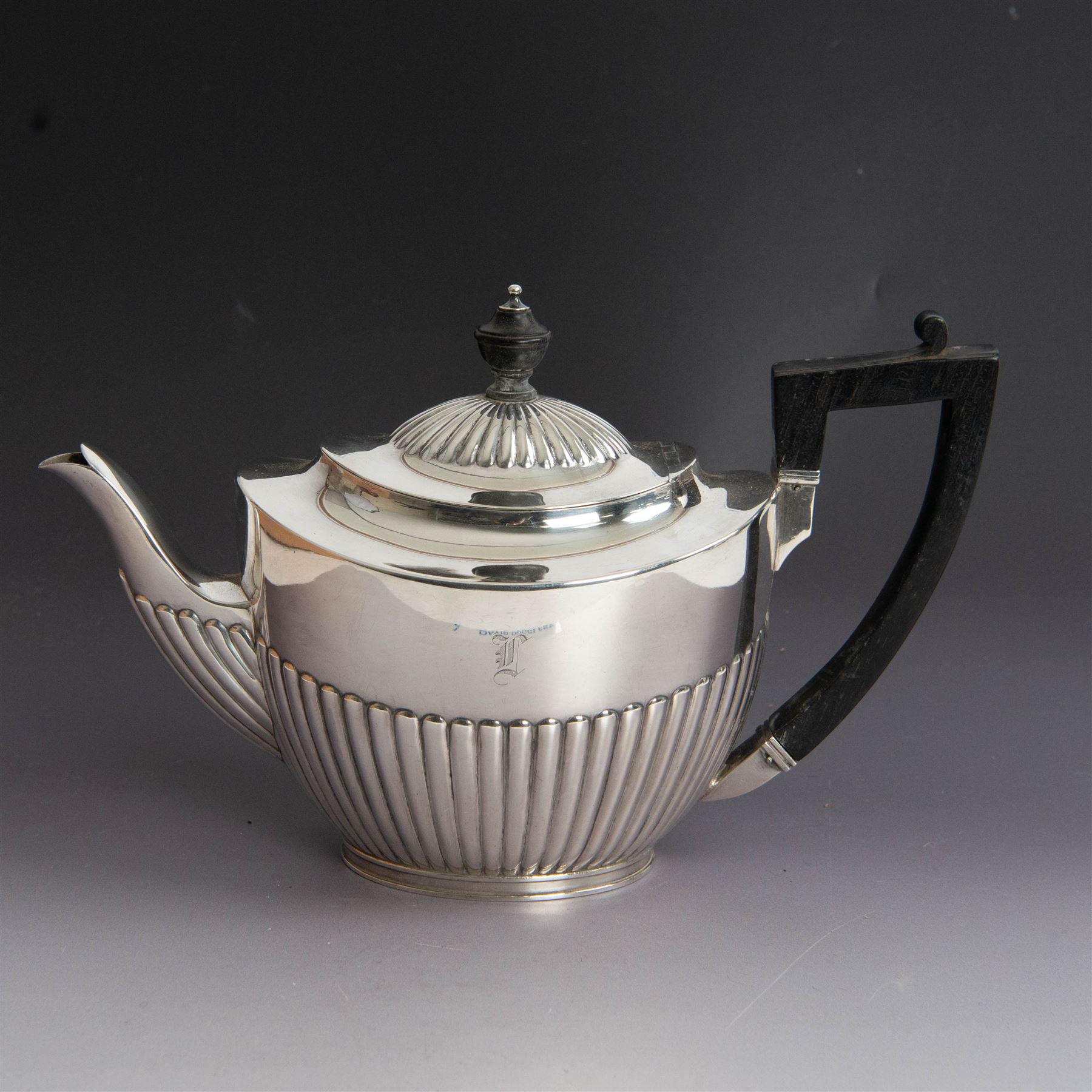 Victorian silver four piece tea service, comprising coffee pot, teapot, twin handled open sucrier and milk jug, all of oval part fluted form and engraved with initial to body, the coffee pot on oval stepped foot, coffee pot and teapot with ebonised wooden finials, hallmarked Elkington & Co, Birmingham 1888