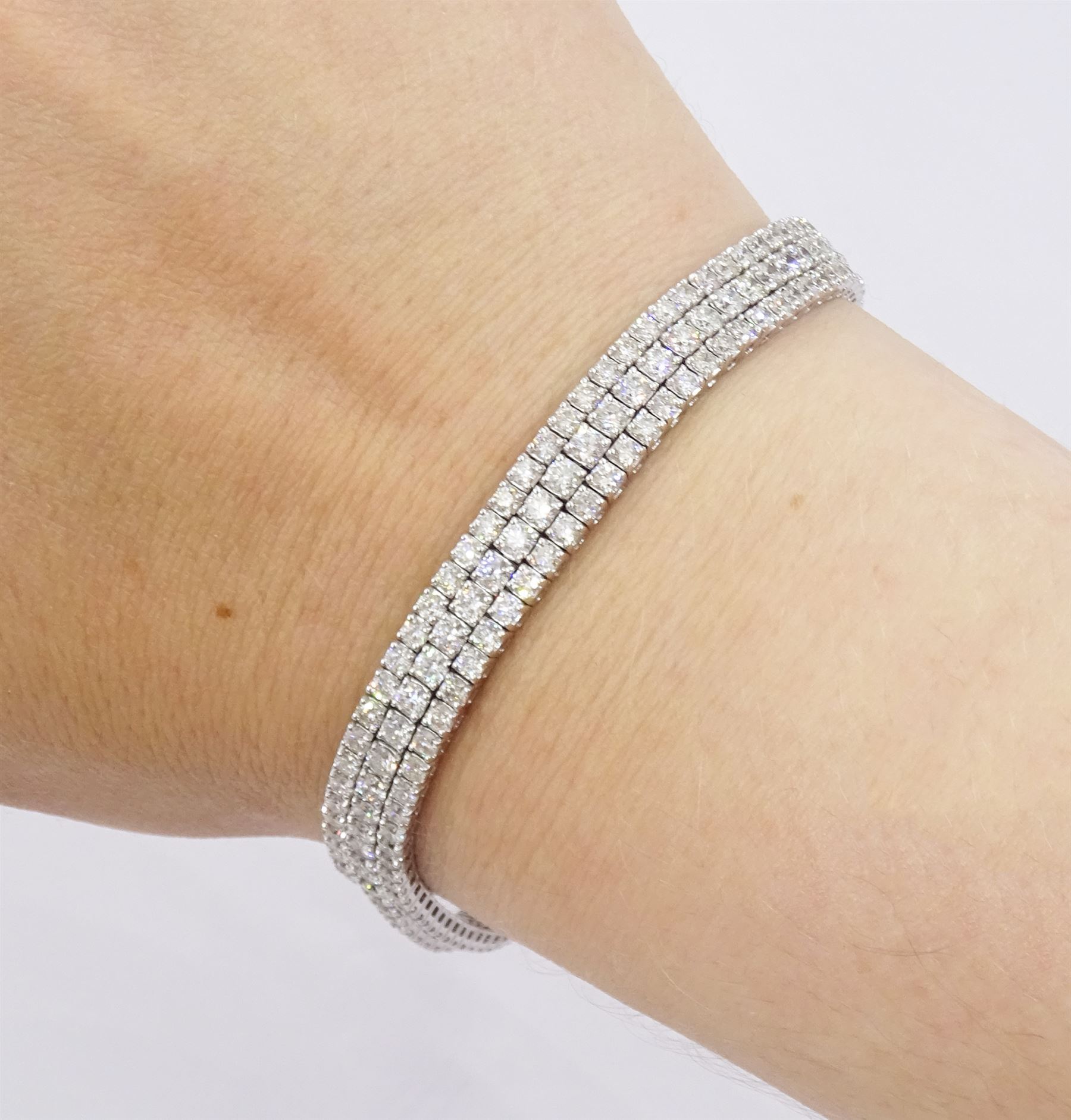 18ct white gold diamond three row bracelet, each four claw set with round brilliant cut diamonds, stamped, total diamond weight approx 7.70 carat