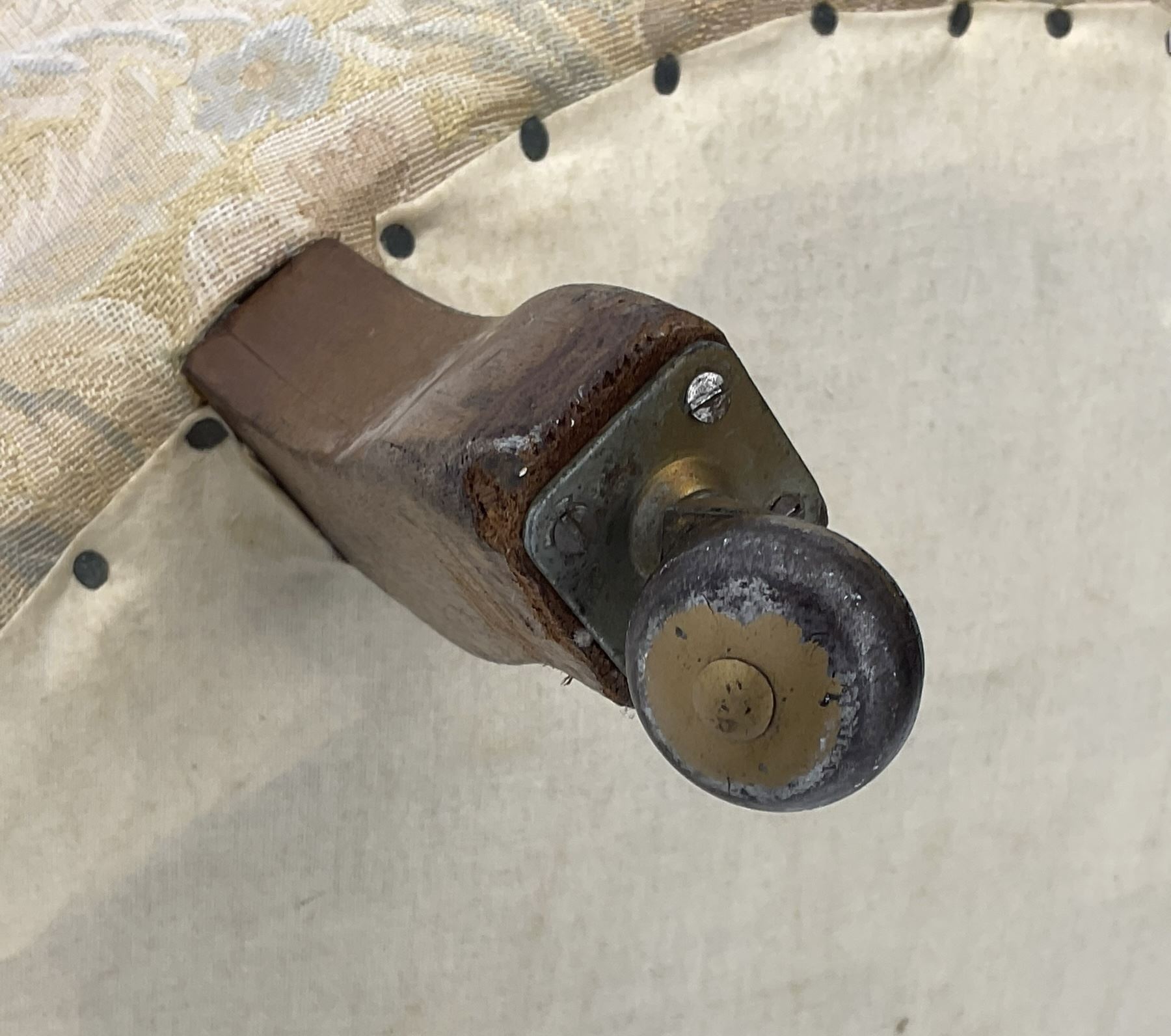 Victorian walnut framed nursing chair, upholstered in buttoned floral pattern fabric, on turned front feet 