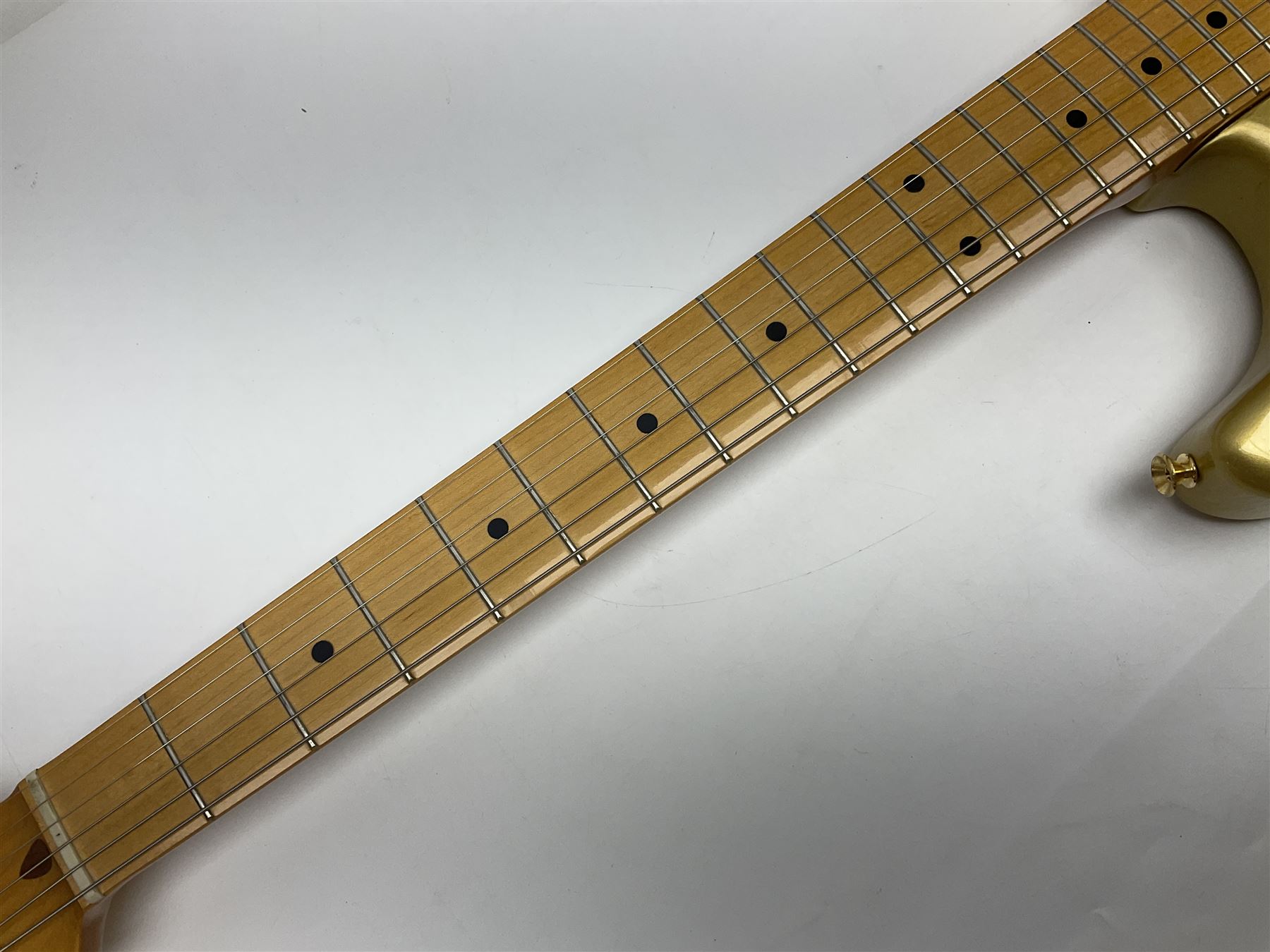 Fender Stratocaster 50th Anniversary 2004 metallic gold electric guitar; serial no.MZ4116369; L98cm; in Spider fitted case with owners manual and other paperwork, strap and belt buckle etc