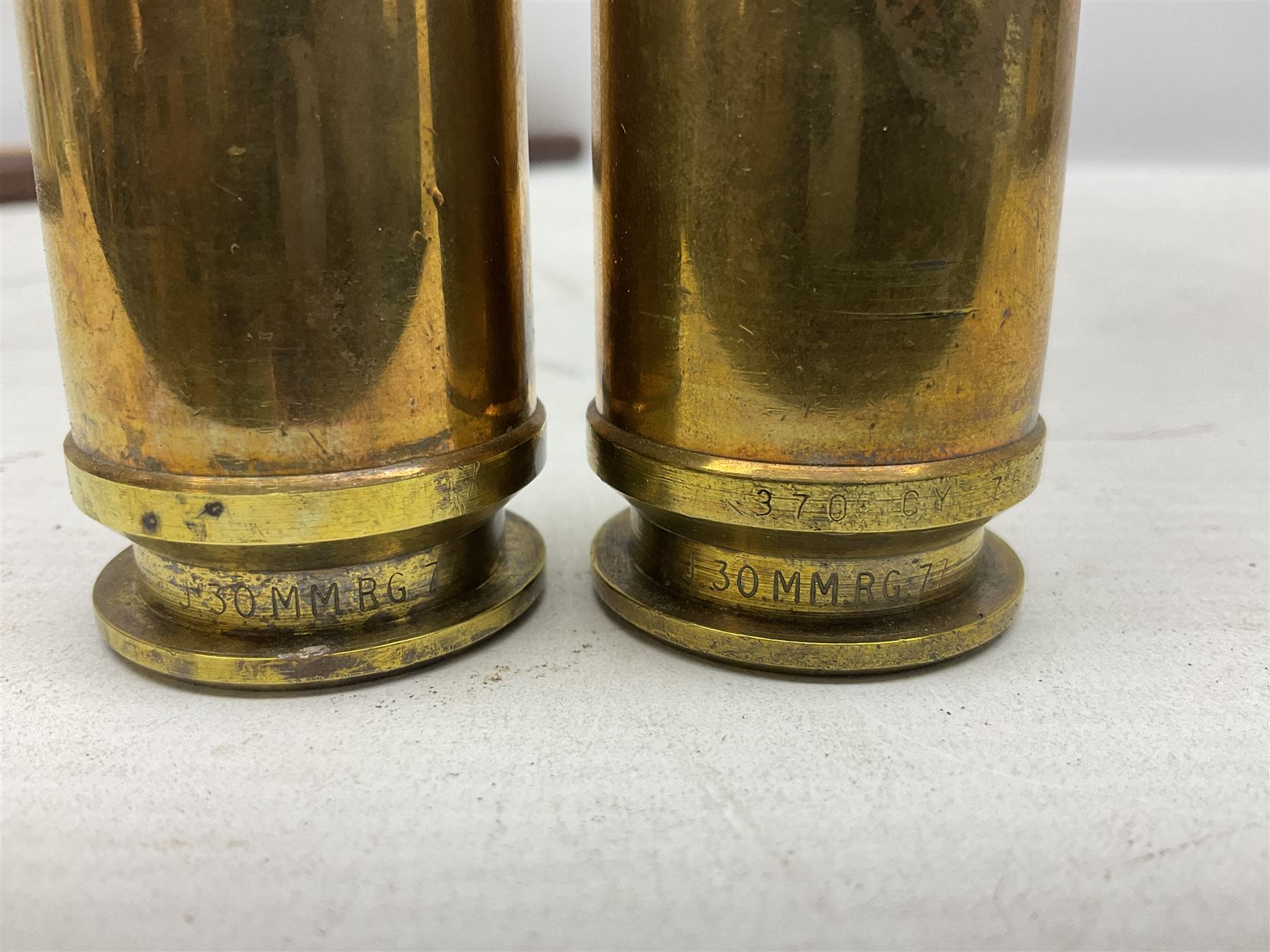 WW2 copper and brass bugle inscribed George Potter & Co, Aldershot 1939 L28cm; two cane and one leather covered swagger sticks; and three small pairs of plain brass shell cases (10)