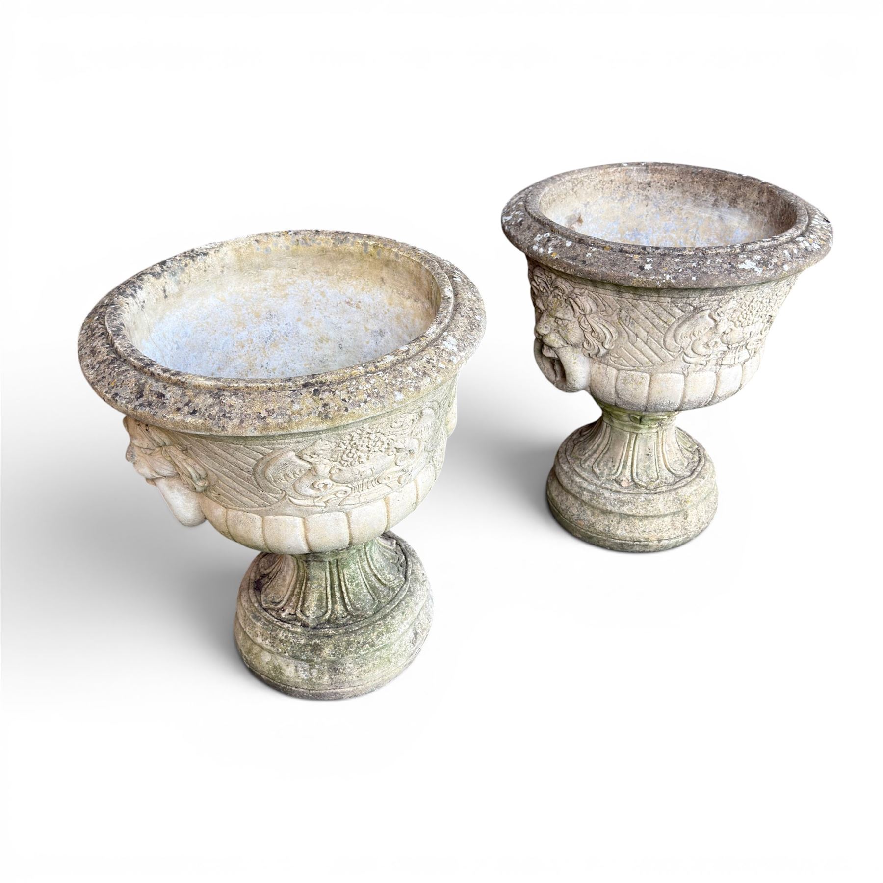 Pair of classic design cast stone garden urns, circular bowl detailed with lion mask loop handles
