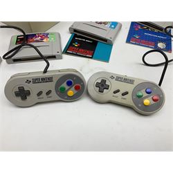 Two Super Nintendo Entertainment System (PAL) controllers, accessories and games. Super NES Game Commander with original box and instruction booklet, Super NES Nintendo Scope (1992) transmitter gun, receiver, Super NES Nintendo Scope 6 game with original instruction booklets. Further games to include ‘The Legend of Zelda a Link to the Past’, ‘Super Mario World’, ‘Super Mario Kart’, ‘The Lawnmower Man’, and ‘Exhaust Heat’, all with original instruction booklets. ‘PowerMonger’ and Disney’s ‘Aladdin’ game cartridges only 