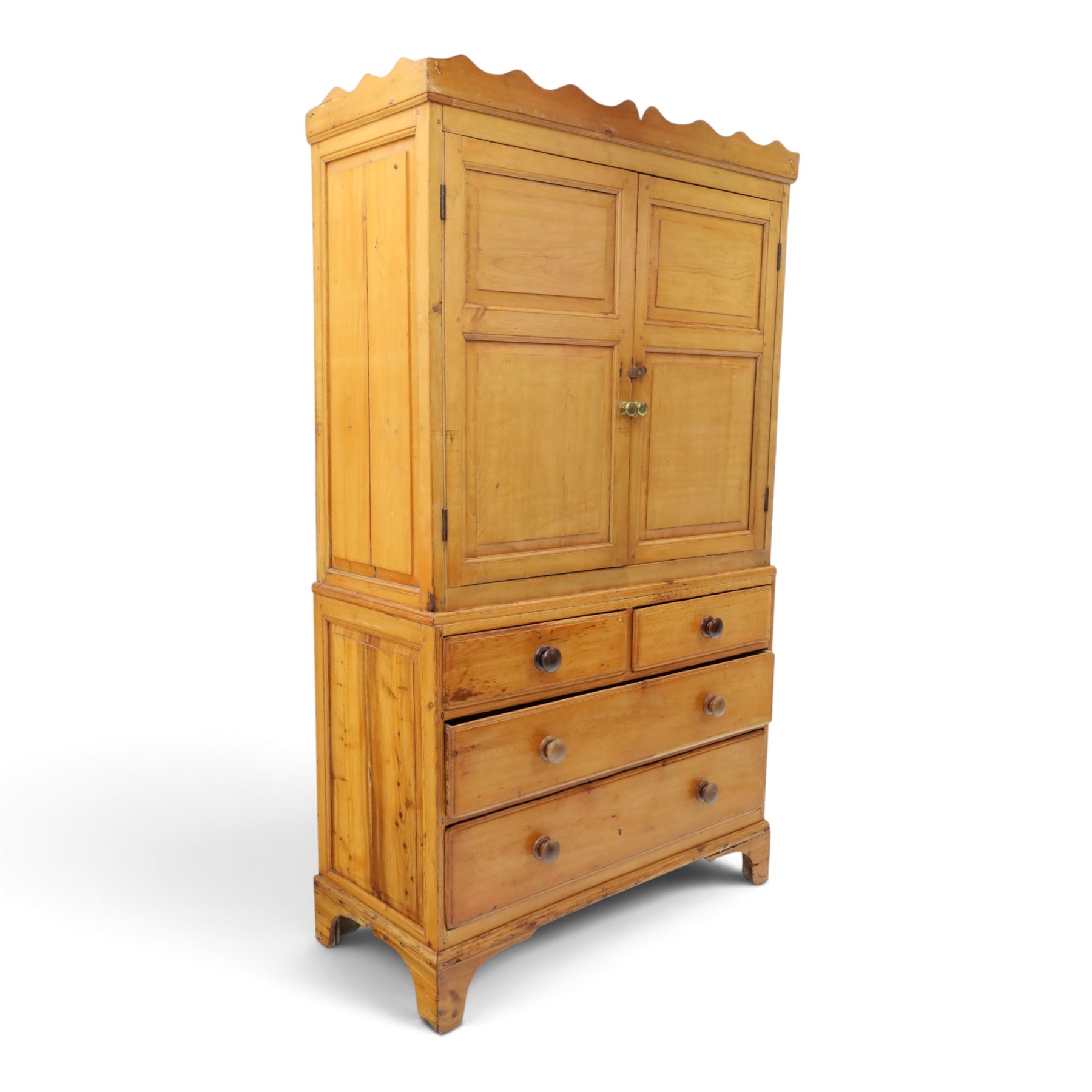19th century waxed pine press cupboard, shaped cornice above a twin fielded panelled cupboard door enclosing a fixed shelf, the lower section two short two long drawer