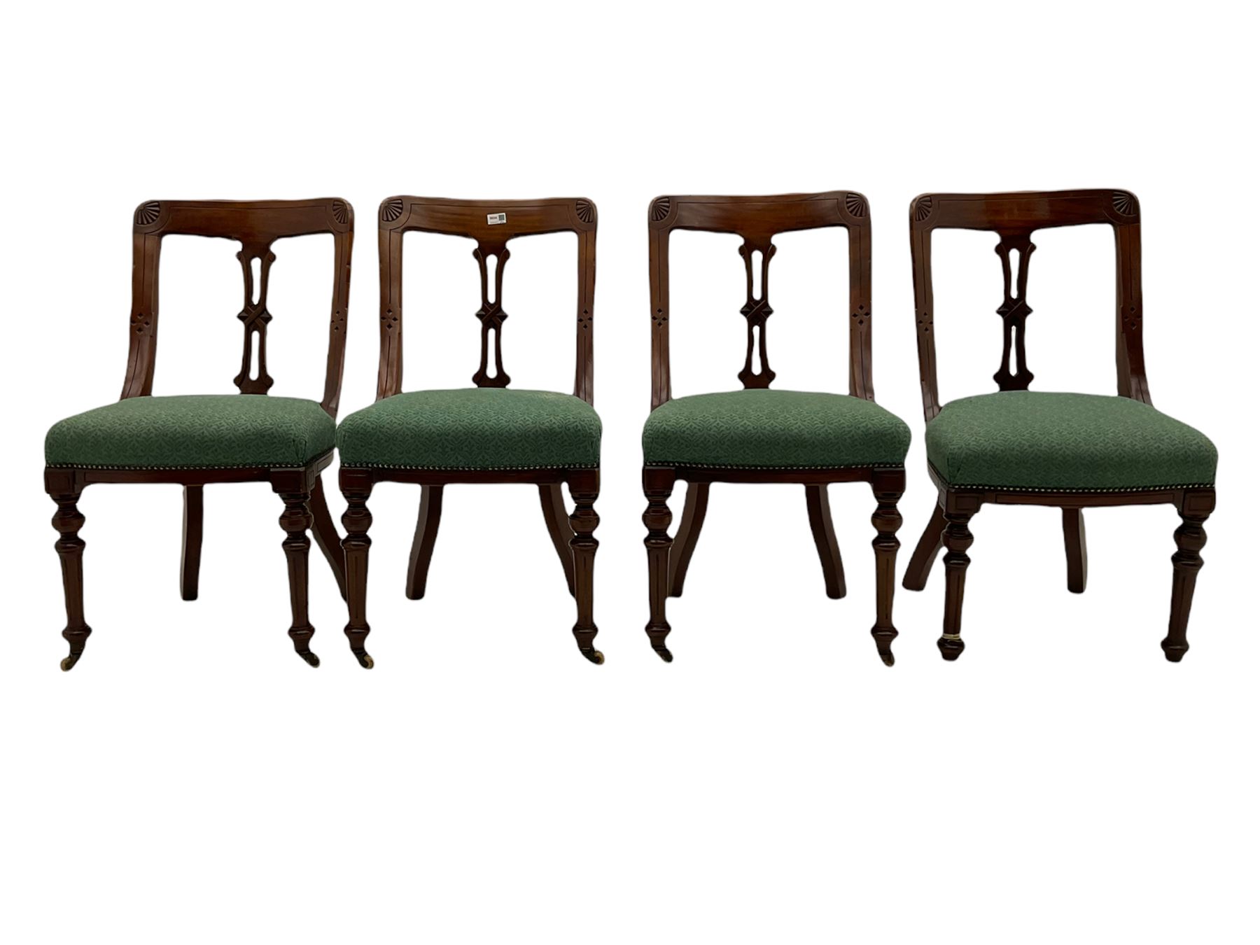 Set of four Victorian mahogany spoon back dining chairs, upholstered seats
