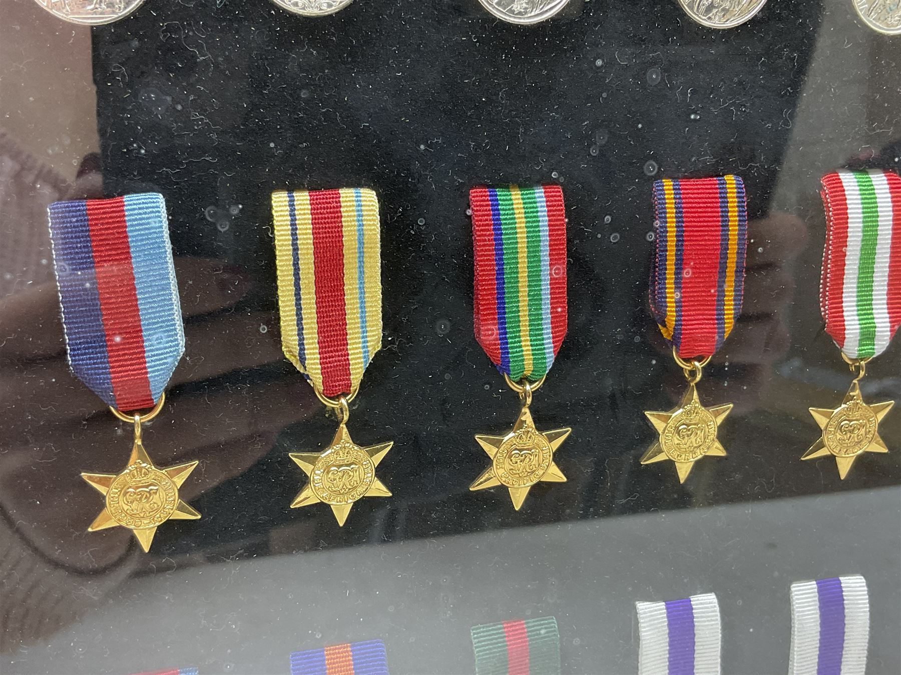 Limited edition large framed display board with sixty half-size copies of British Gallantry and Campaign Medals produced by Danbury Mint; all with ribbons and associated booklet