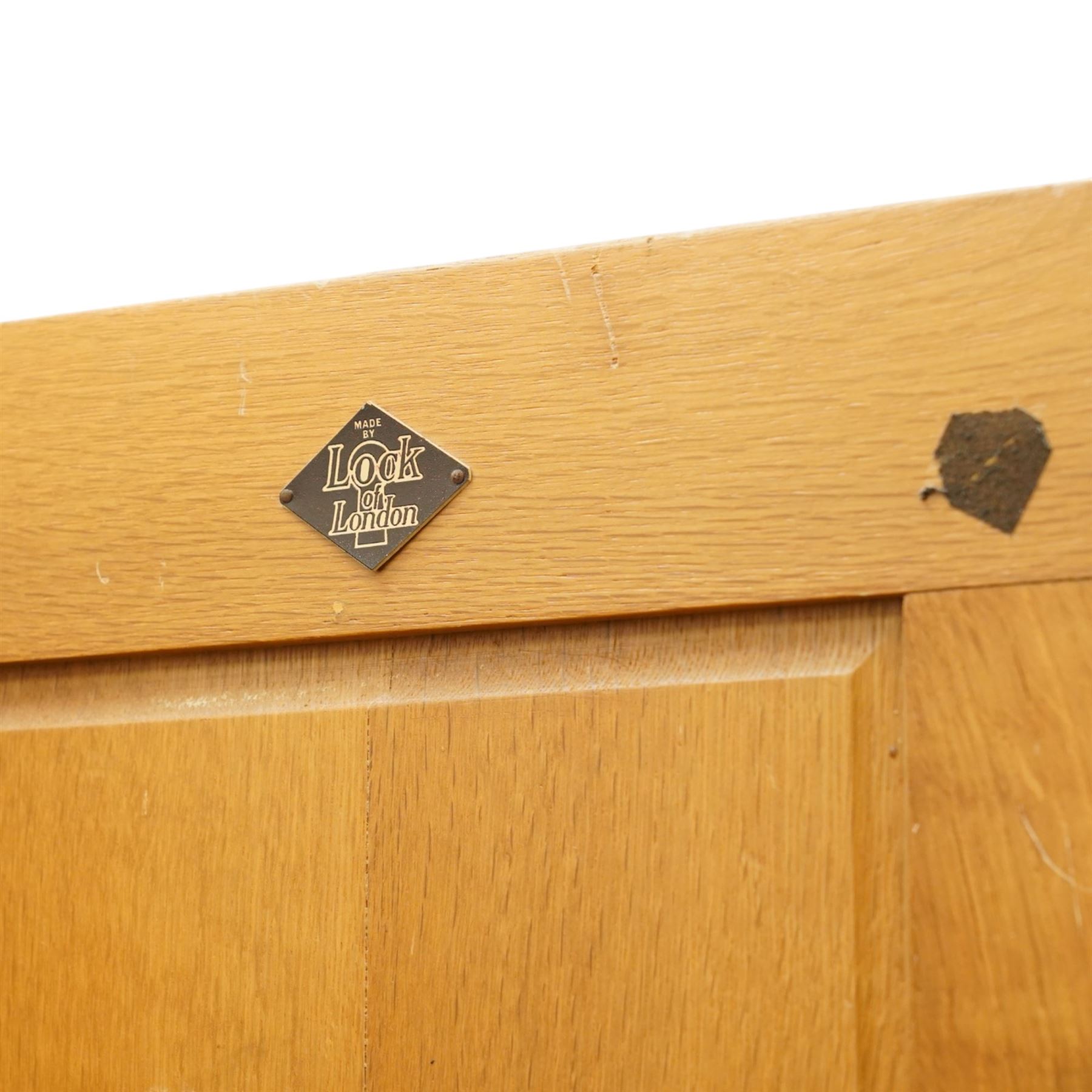 Arts & Crafts design limed oak bedroom suite; comprising dressing table, single wardrobe and chest, with carved scrolling motifs.

Wardrobe (H 181cm, D 47cm, W 79cm)
Chest (H 74cm, D 46cm, W 73cm)
Dressing table (H 136cm, D 47cm, W 74cm)