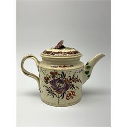 18th century creamware teapot, probably Leeds, with reeded entwined handle and floral finial to the cover, the body with hand painted polychrome decoration of figure to one side, and floral spray to the other, collectors paper label beneath inscribed Leeds Pottery, H11.5cm