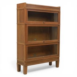 Globe Wernicke - Modular oak sectional bookcase, the three glazed up-and-over doors with p...