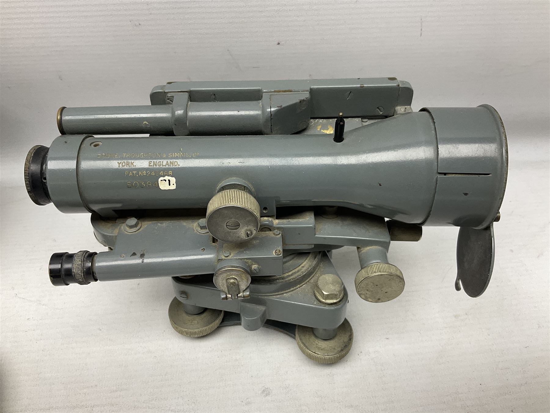 Cooke Troughton & Simms grey painted brass dumpy level in carrying case; and WW2 British .303 Vickers Machine Gun brass Clinometer, stamped 'V.E. 0067' serial No. 2370,  dated 1944 unboxed (2)