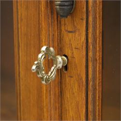 Pair of late 20th century Thai hardwood display cabinets, each with moulded cornice over twin glazed doors enclosing adjustable shelves, panelled cupboard doors below flanked by fluted columns, raised on bun feet