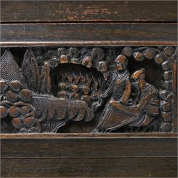Early 20th century Chinese export carved hardwood writing bureau, the sloped fall front deeply carved with a narrative figural scene beneath pine and prunus trees, above a pair of rectangular carved panels, the shaped crest rail with entwined dragons, interior fitted with pigeonholes and a central drawer, on figural front supports with shaped stretcher