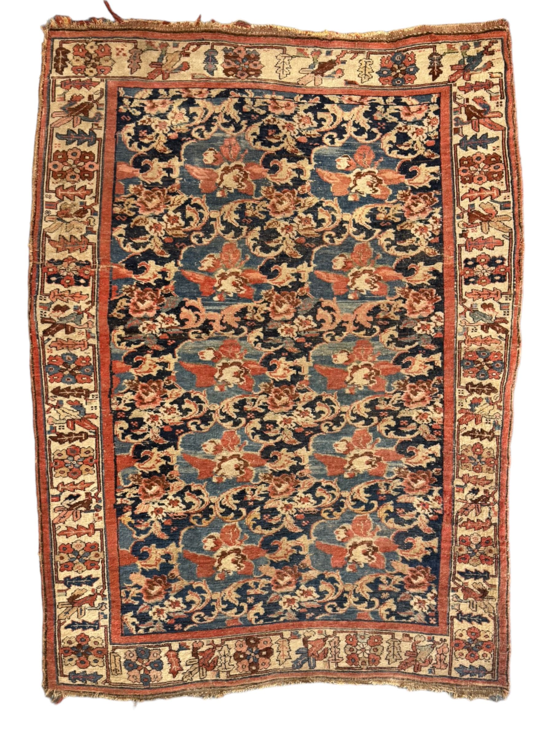 Persian Bidjar indigo ground rug, the busy field decorated with large floral motifs, the guarded ivory border adorned with repeating flower heads and stylised leaves
