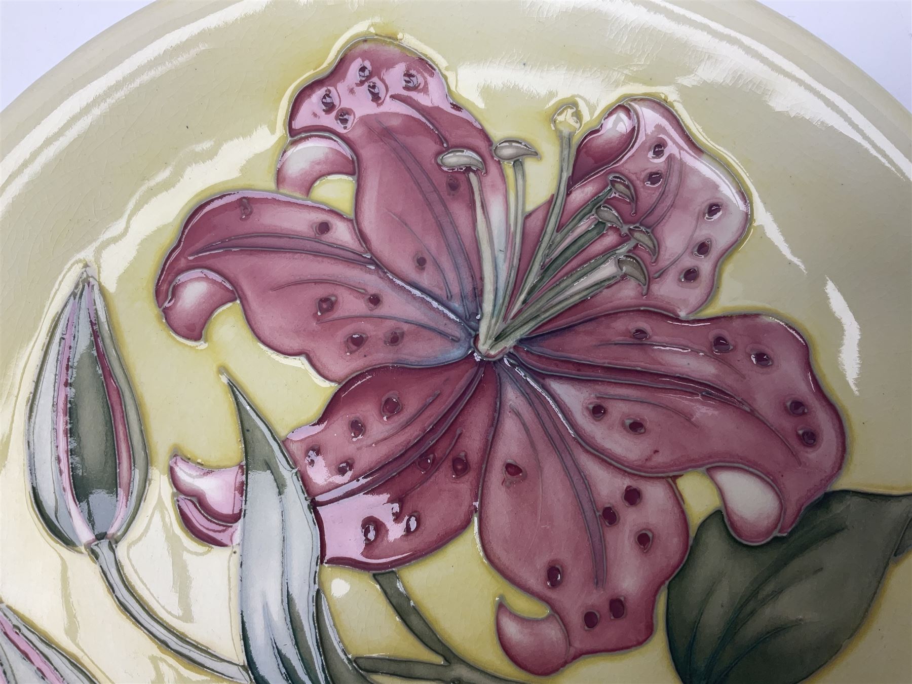Moorcroft Tiger Lily pattern plate on a yellow ground, with painted and impressed mark beneath, D26cm