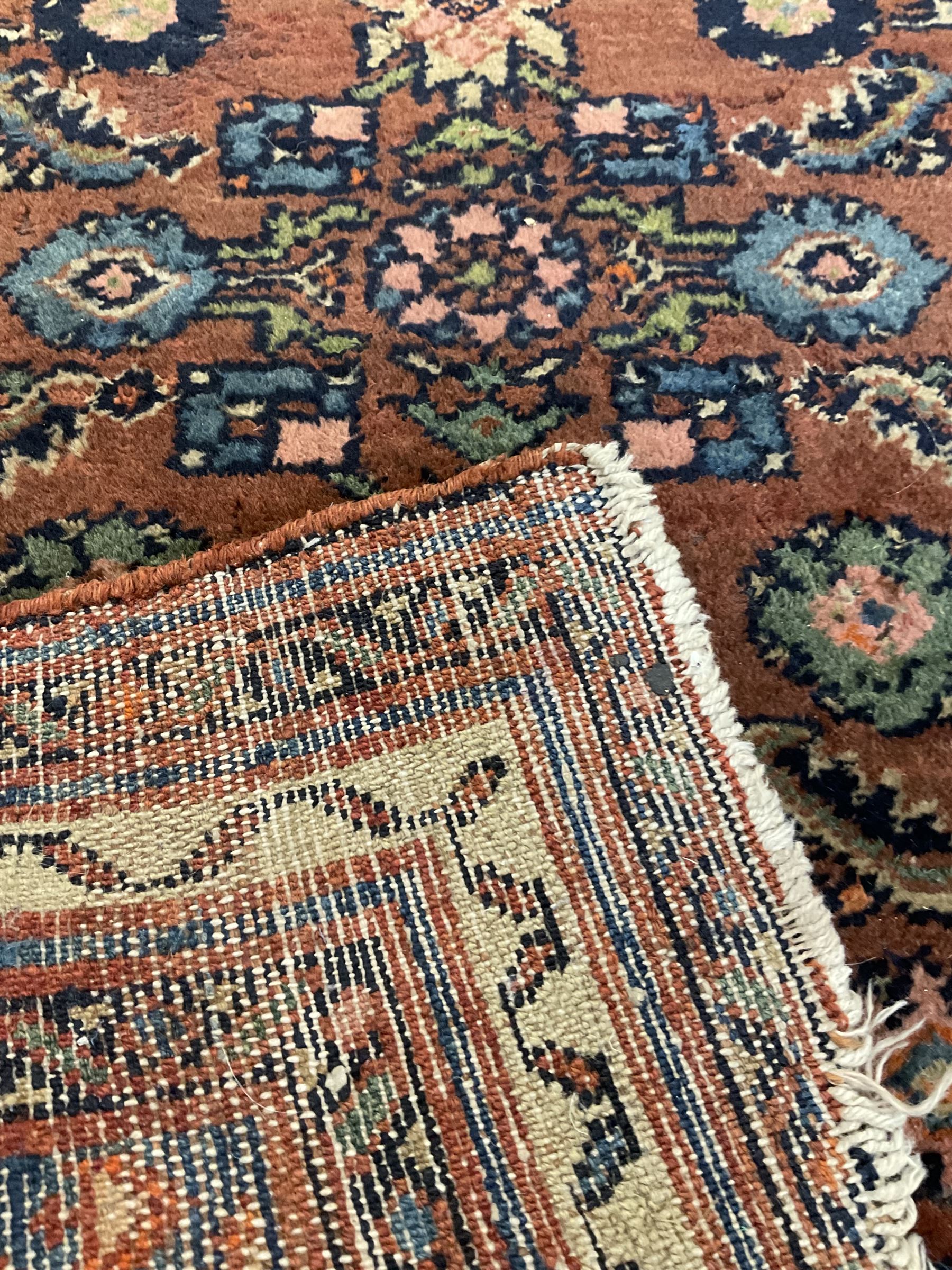 Small Persian rug or mat, decorated with Herati motifs within pattern borders 