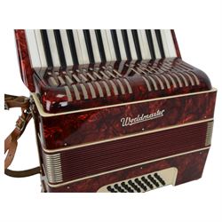 World master piano accordion with  14 fold bellows, two octave keyboard and 32 buttons. With a hard carrying case.