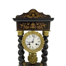 French - 19th century 8-day ebonised portico clock, shaped pediment with inlay and four barley twist columns with brass capitals, double plinth with conforming inlay, enamel dial with a filigree stamped bezel, Roman numerals, minute markers and maltese cross hands, distinctive repousse pendulum, twin train Parisian count wheel striking movement, striking the hours and half-hours on a bell. 