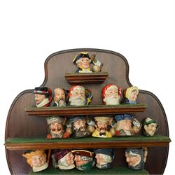 Collection of  forty two miniature Royal Doulton character jugs on three wall shelves, one inscribed Royal Doulton