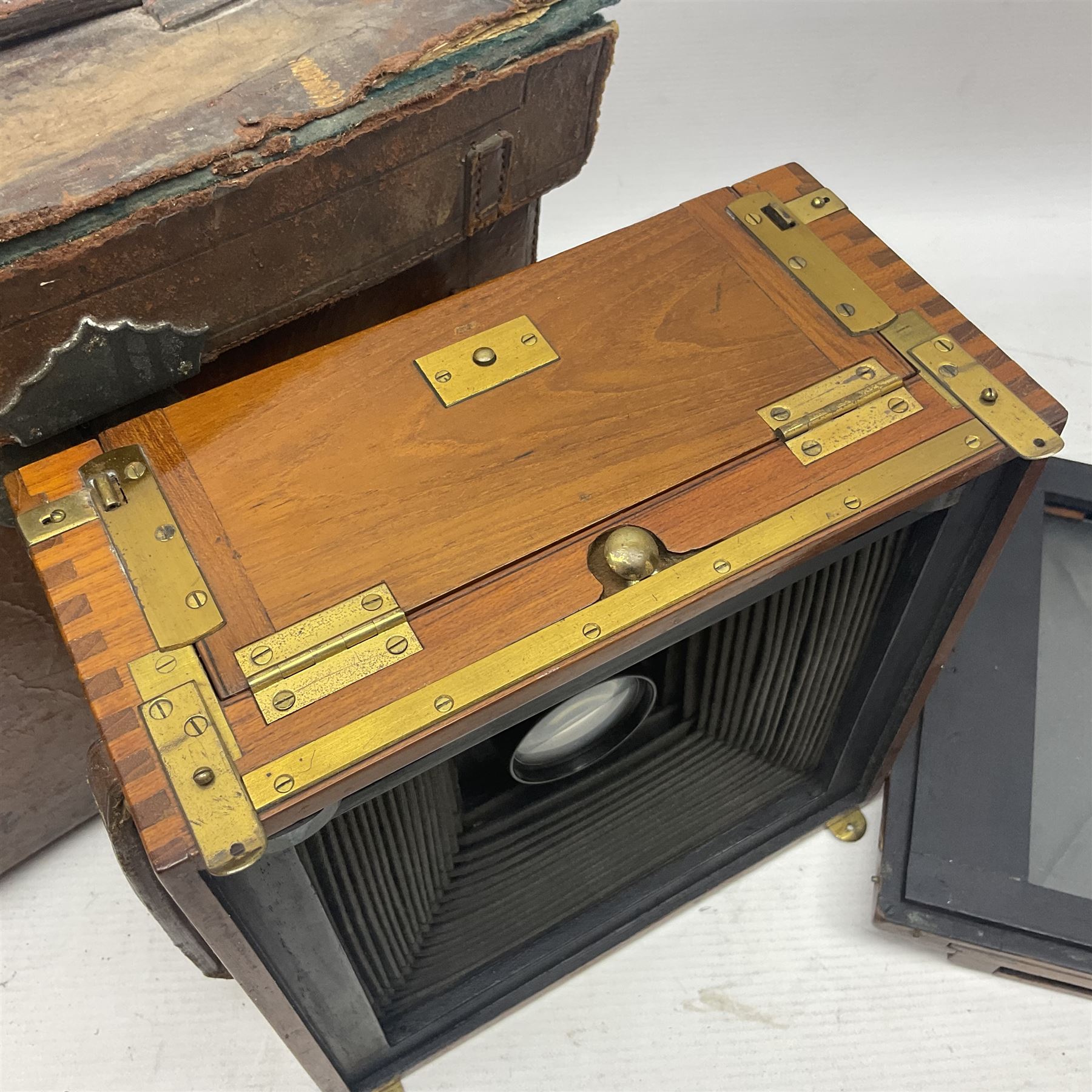 Sanderson Koilos folding plate camera in mahogany and lacquered brass, with 'Ensign Anastigmat Series IV No 2' lens, serial no 173998, with original leather case