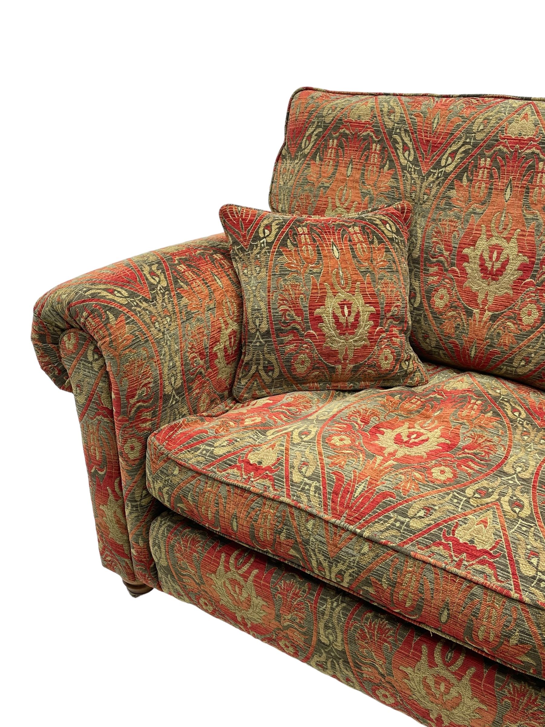 Duresta - 'Beaminster' grande two-seat sofa, traditional shape with rolled arms, upholstered in 'Althorp' russet and stone floral pattern fabric, on turned feet with brass castors
