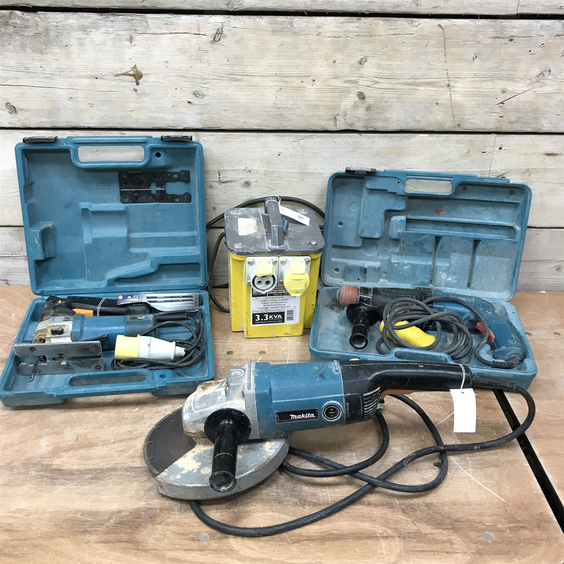 Makita 9069 9' 110V grinder, Makita HR2410 110V drill, a Mikita 4304T jigsaw and a 110v transformer - The Furnishings Sale - Furniture Interiors