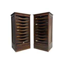 Two early 20th century mahogany tambour cabinets, each with retractable roll-top front revealing fitted interior with concave-front filing drawers and brass fittings