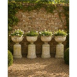 Four 20th century good quality weathered cast stone pedestal urns, circular lobed bowls wi...