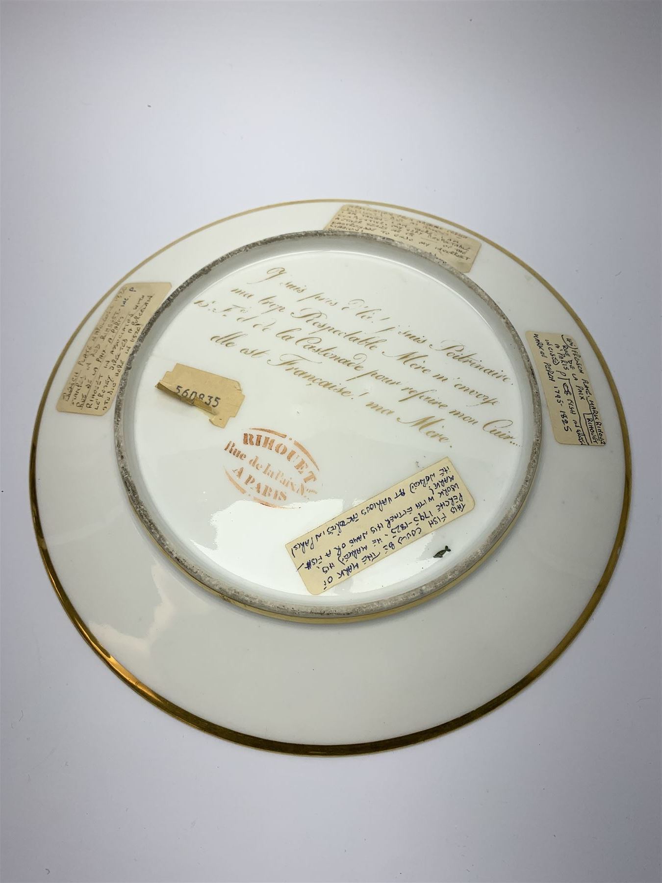 19th century Rihouet Paris porcelain cabinet plate, decorated with a central panel illustrating three French soldiers around a bottle laden table, one surveying a note, within a dark blue gilt detailed border, with French inscription verso, and red printed mark Rihouet Rue de la Paix A Paris and green fish mark, possibly for Perche, D23cm 




