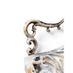 Pair of Victorian cast iron garden chairs, the ornate pierced back of scrolling foliate design, scrolling arm terminals over splayed supports formed of C and S-scrolls, in distressed white painted finish