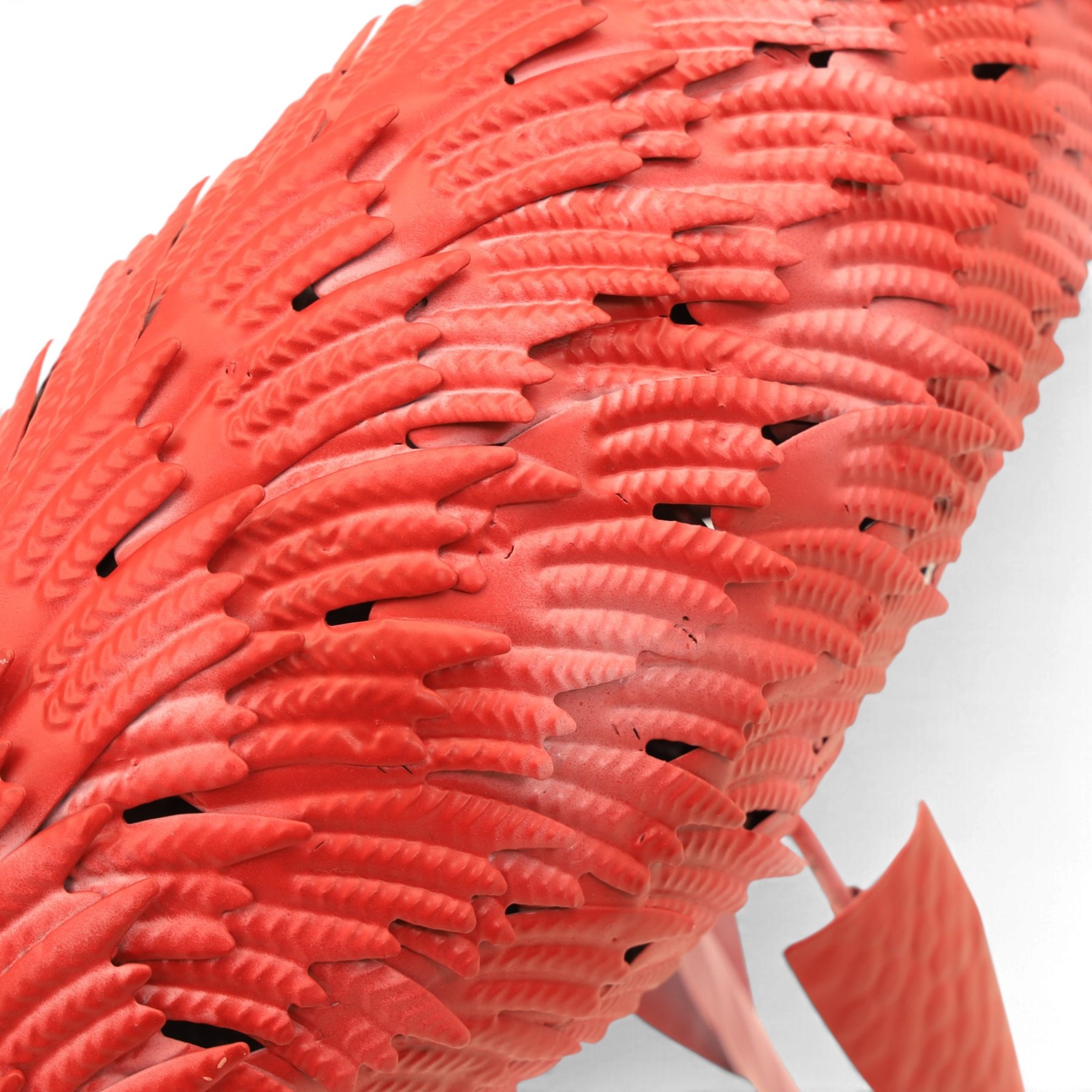 Pair of contemporary pink painted metal flamingos, with elongated curved necks, black-tipped beaks and overlapping pierced metal plumage, on long slender legs terminating in three-toed feet, modelled in differing poses