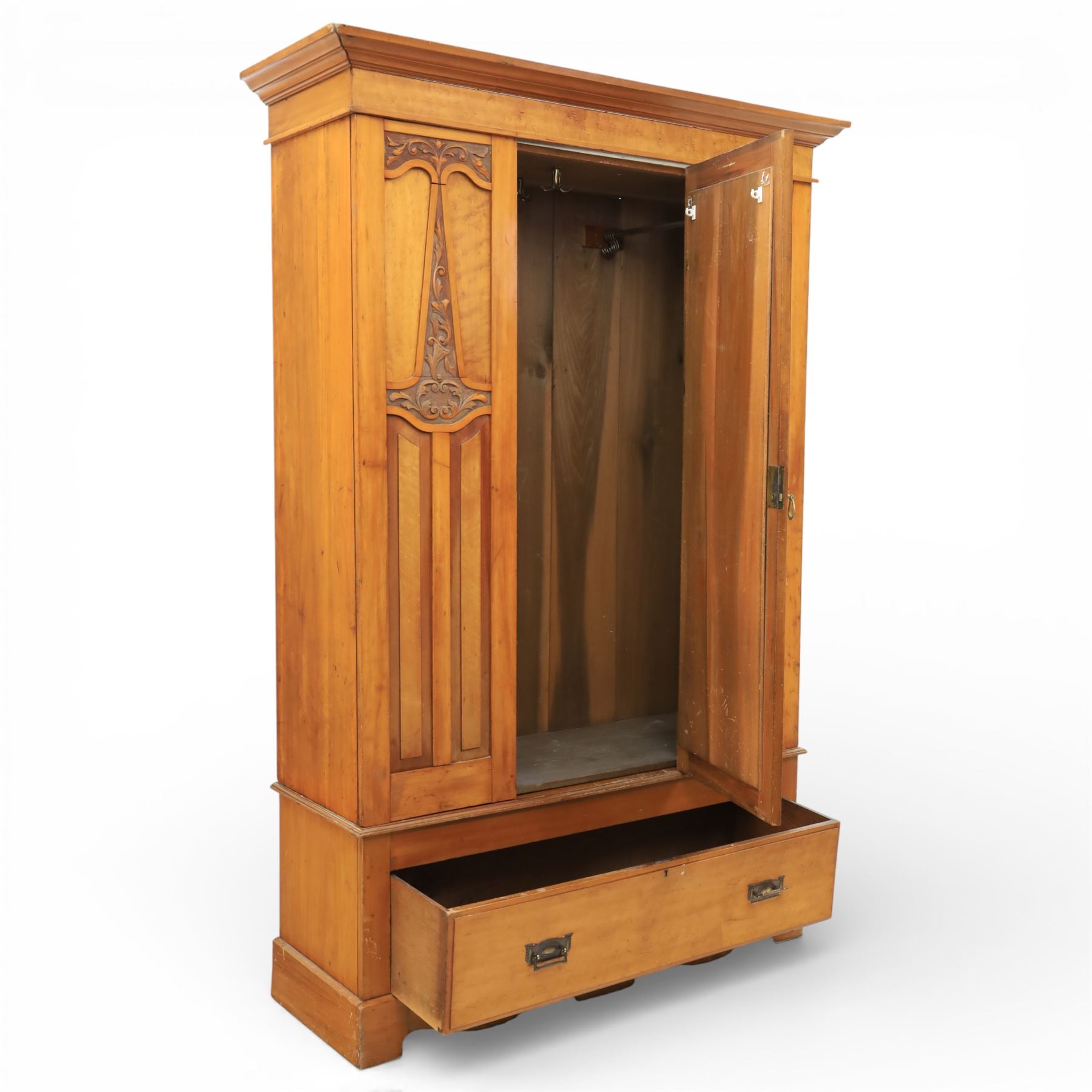 Early 20th century Art Nouveau walnut wardrobe, rectangular top over with single central mirrored panel door, the outer sides carved with sinuous foliate decoration and stylised stem motifs above recessed panels, single long drawer below with brass drop handles, on moulded plinth