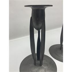 Pair of Solkets English pewter candlesticks, the bud shaped sockets raised upon three angular fin supports and a slightly domed circular base with cast stylised foliate decoration, H23cm