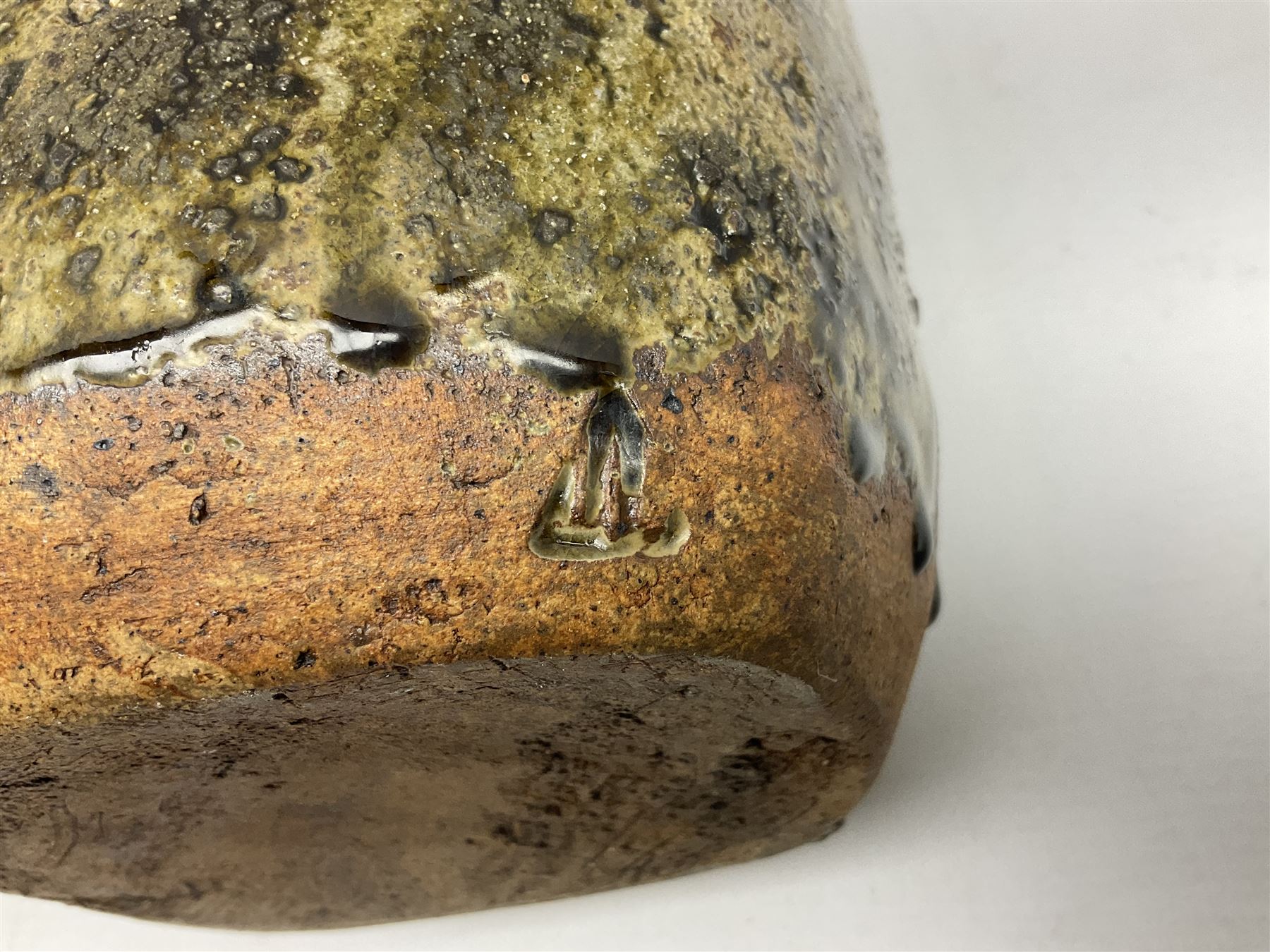 Janet Leach (American, 1918-1997) for Leach Pottery; studio pottery Bizen style vase of tapering form, the stoneware body decorated in a mottled green and brown dripped ash glaze, with impressed J.L. monogram and stamp marks beneath, H30cm