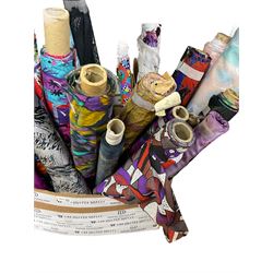 Haberdashery Shop Stock: Various rolls of fabric including metallic printed stage satin, abstract and geometric patterns, children's and festive fabric, and others (qty) in two boxes
