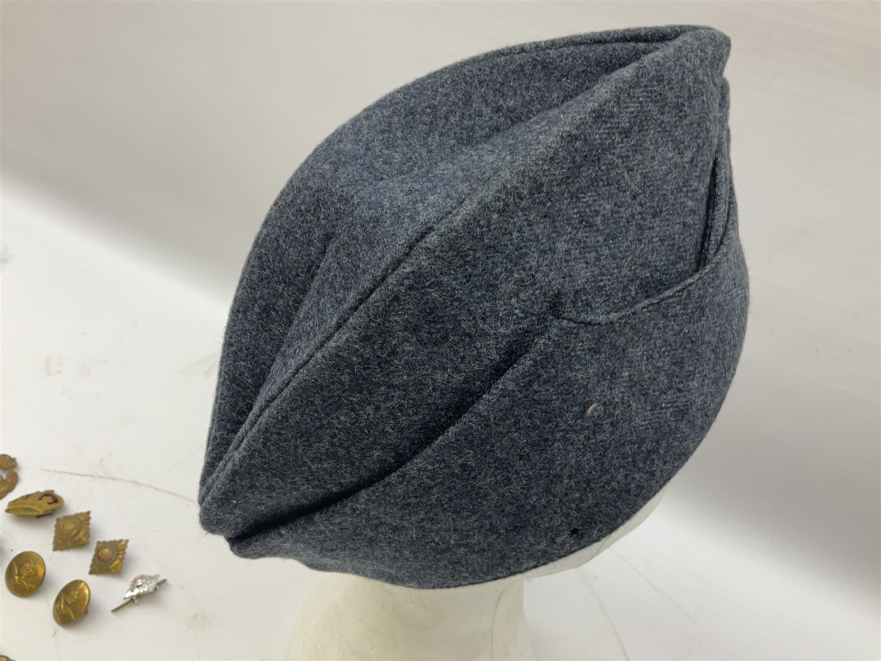 WW2 RAF sidecap dated 1942 with badge and buttons; quantity of RAF metal and cloth badges, pips and buttons; and paratrooper's helmet chin strap