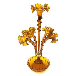 Dark amber glass epergne, with central trumpet surrounded by four smaller trumpets, each with frilled rim and trailed decoration, H59cm.