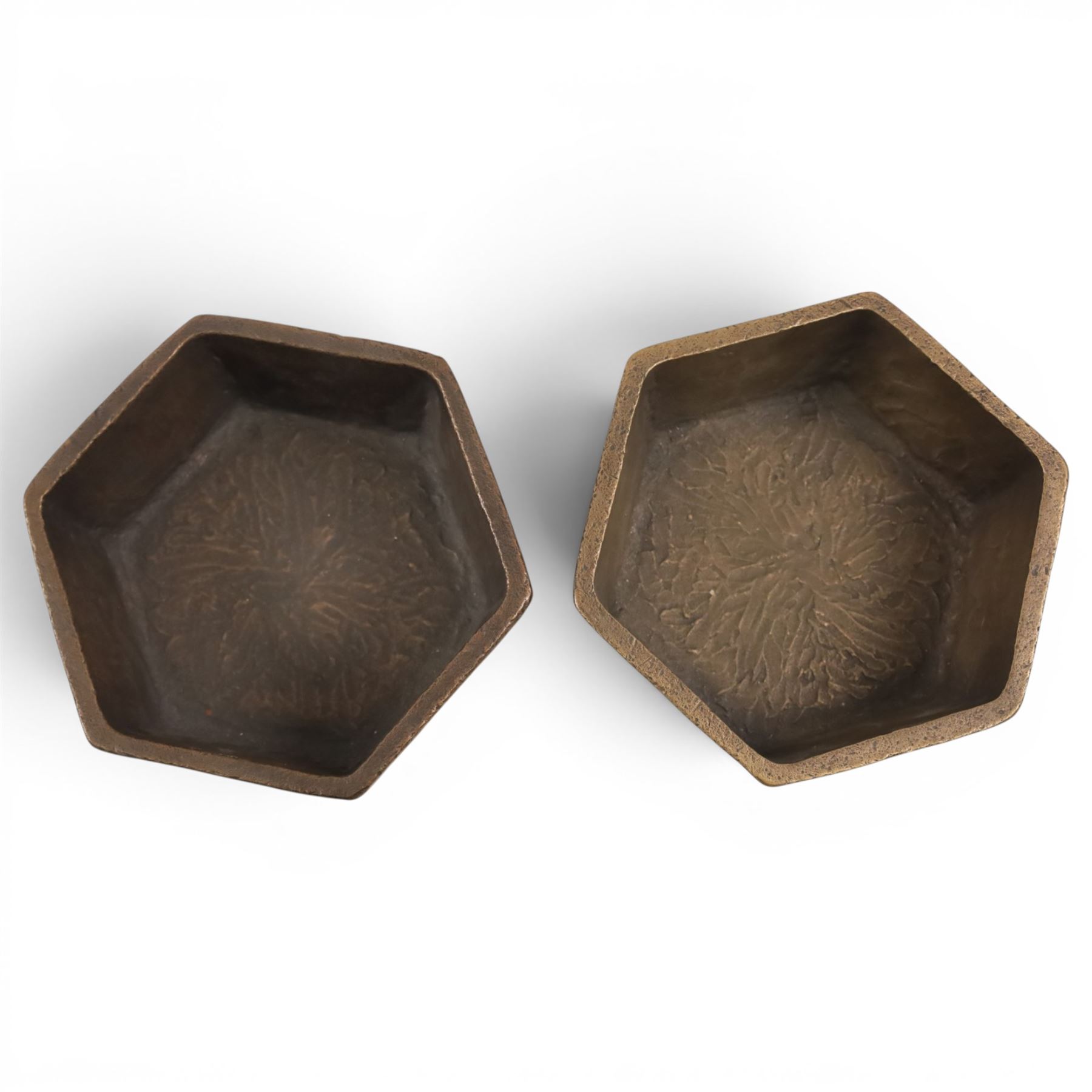 Pair of brutalist candle holders, together with similar wall sconce